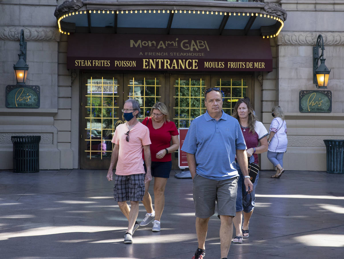 Tourist exit Paris Las Vegas on Friday, Oct. 23, 2020, in Las Vegas. Hundreds of guests at the ...