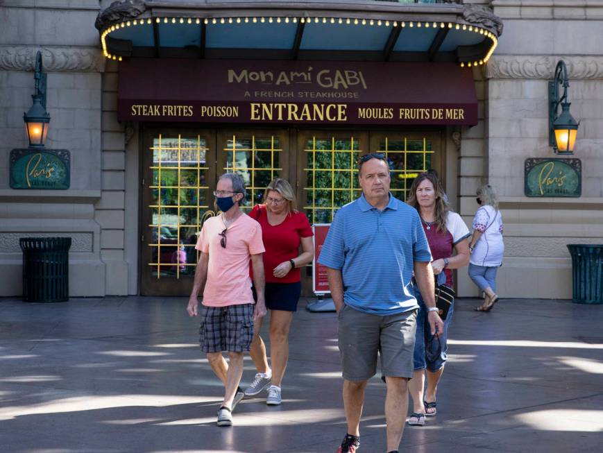 Tourist exit Paris Las Vegas on Friday, Oct. 23, 2020, in Las Vegas. Hundreds of guests at the ...