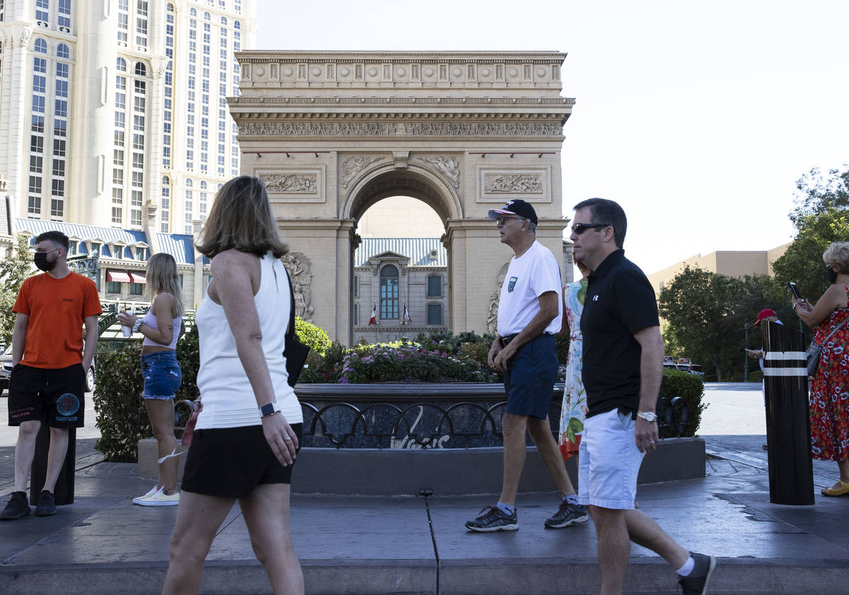 Tourist walk past Paris Las Vegas on Friday, Oct. 23, 2020, in Las Vegas. Hundreds of guests at ...