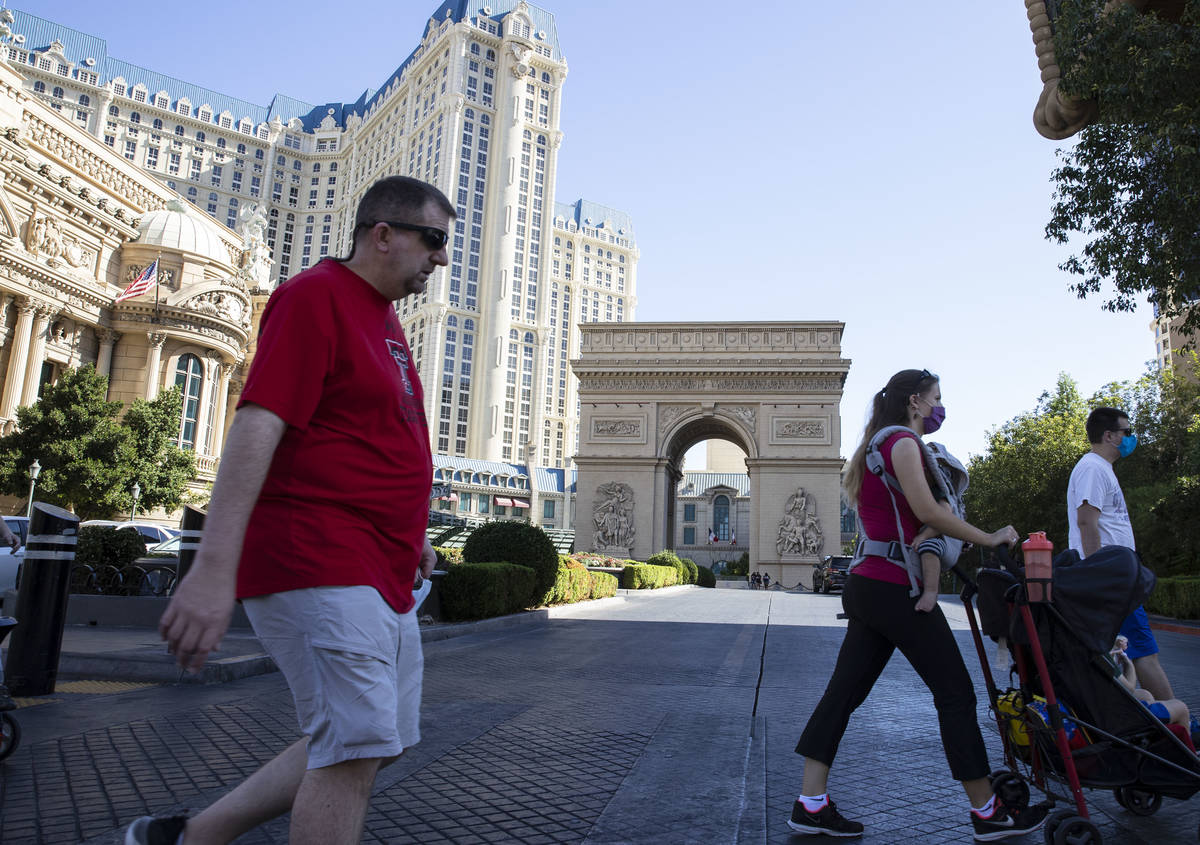 Tourist walk past Paris Las Vegas on Friday, Oct. 23, 2020, in Las Vegas. Hundreds of guests at ...