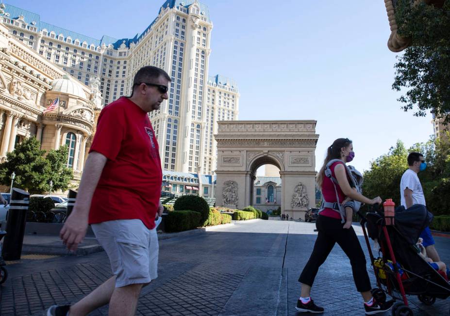 Tourist walk past Paris Las Vegas on Friday, Oct. 23, 2020, in Las Vegas. Hundreds of guests at ...