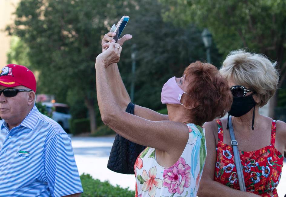 A tourist, who declined to give her name, takes a photo of the Eiffel Tower at Paris Las Vegas ...