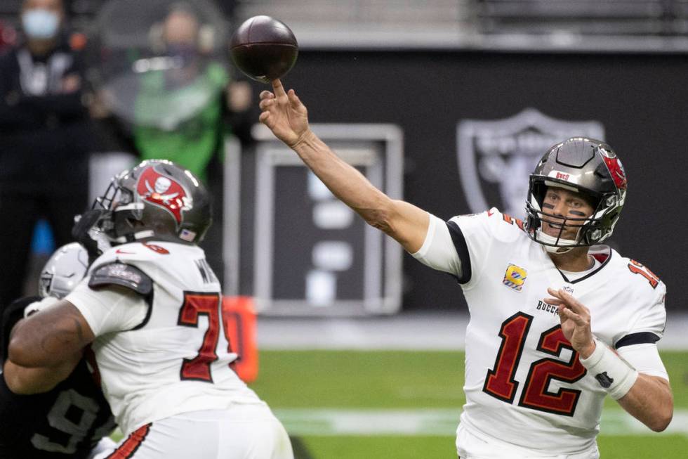 Tampa Bay Buccaneers quarterback Tom Brady (12) makes a sideline pass in the second quarter dur ...