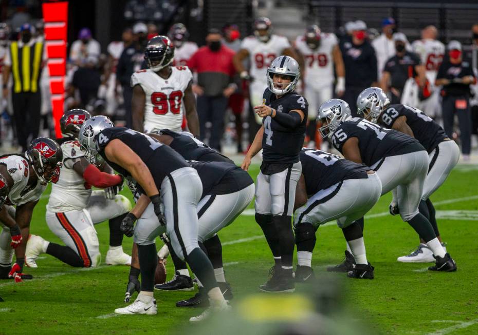 Las Vegas Raiders quarterback Derek Carr (4) points as he yells from the line of scrimmage duri ...