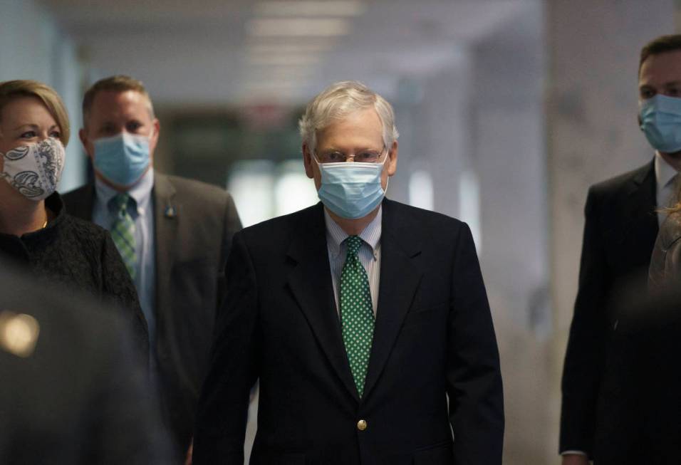 Senate Majority Leader Mitch McConnell, R-Ky., arrives as Republicans work during a rare weeken ...