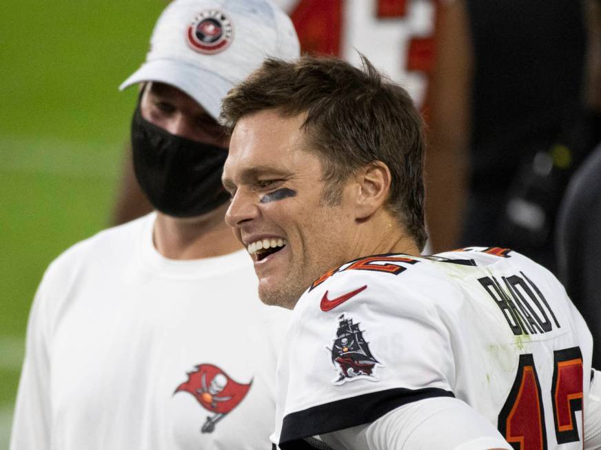 Tampa Bay Buccaneers quarterback Tom Brady (12) shares a laugh with teammates in the fourth qua ...