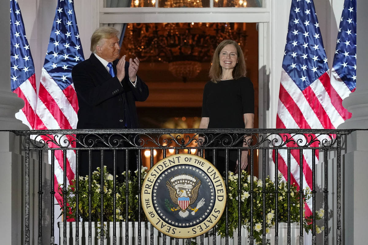President Donald Trump and Amy Coney Barrett stand on the Blue Room Balcony after Supreme Court ...
