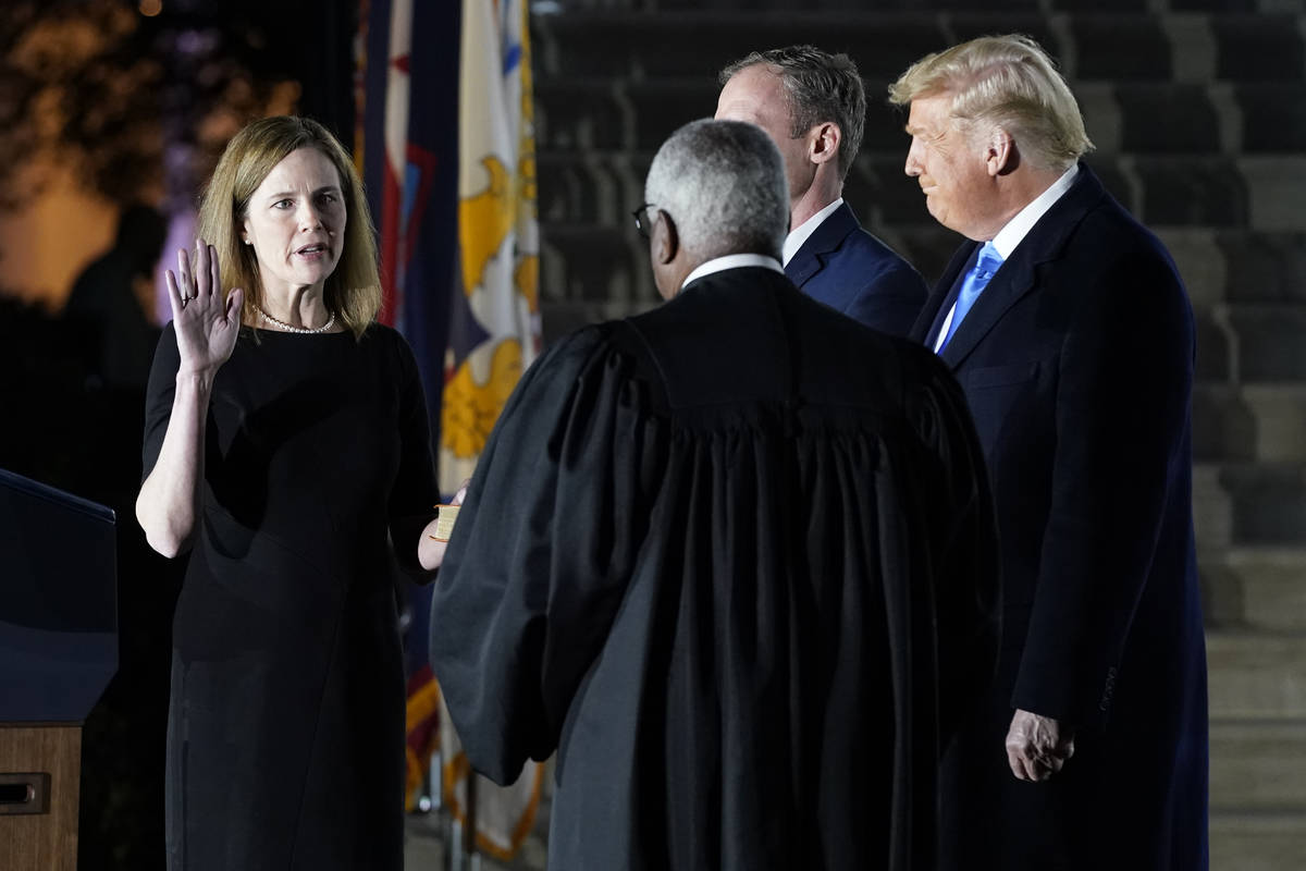 President Donald Trump watches as Supreme Court Justice Clarence Thomas administers the Constit ...