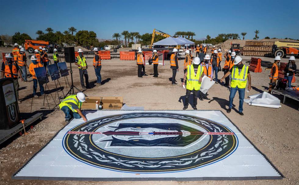 Construction workers put the finishing touches on the Henderson Silver Knights logo during a co ...