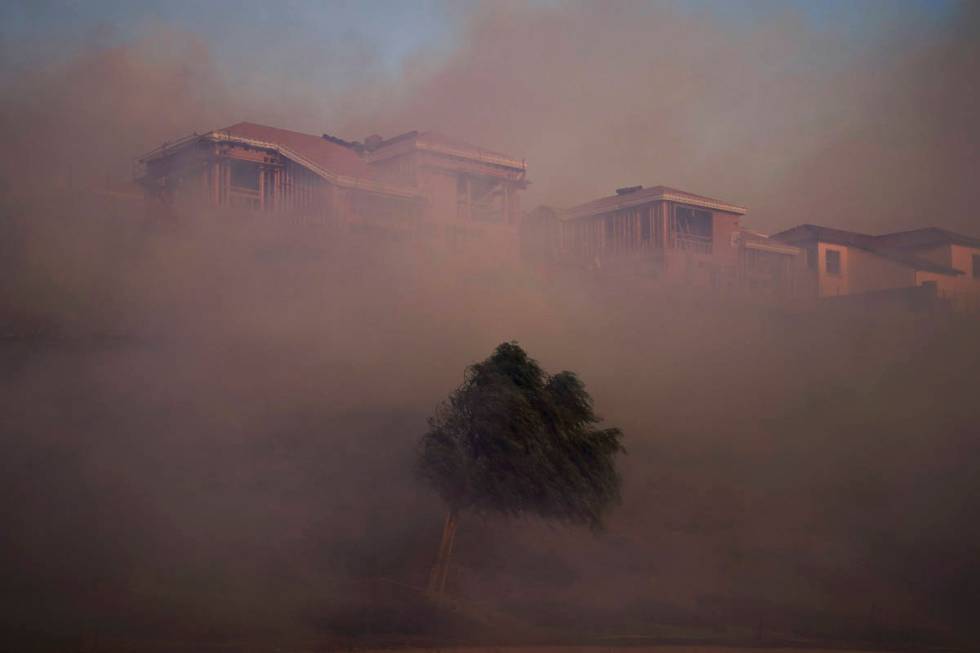 Gusting winds carry smoke from the Silverado Fire into residential areas Monday, Oct. 26, 2020, ...