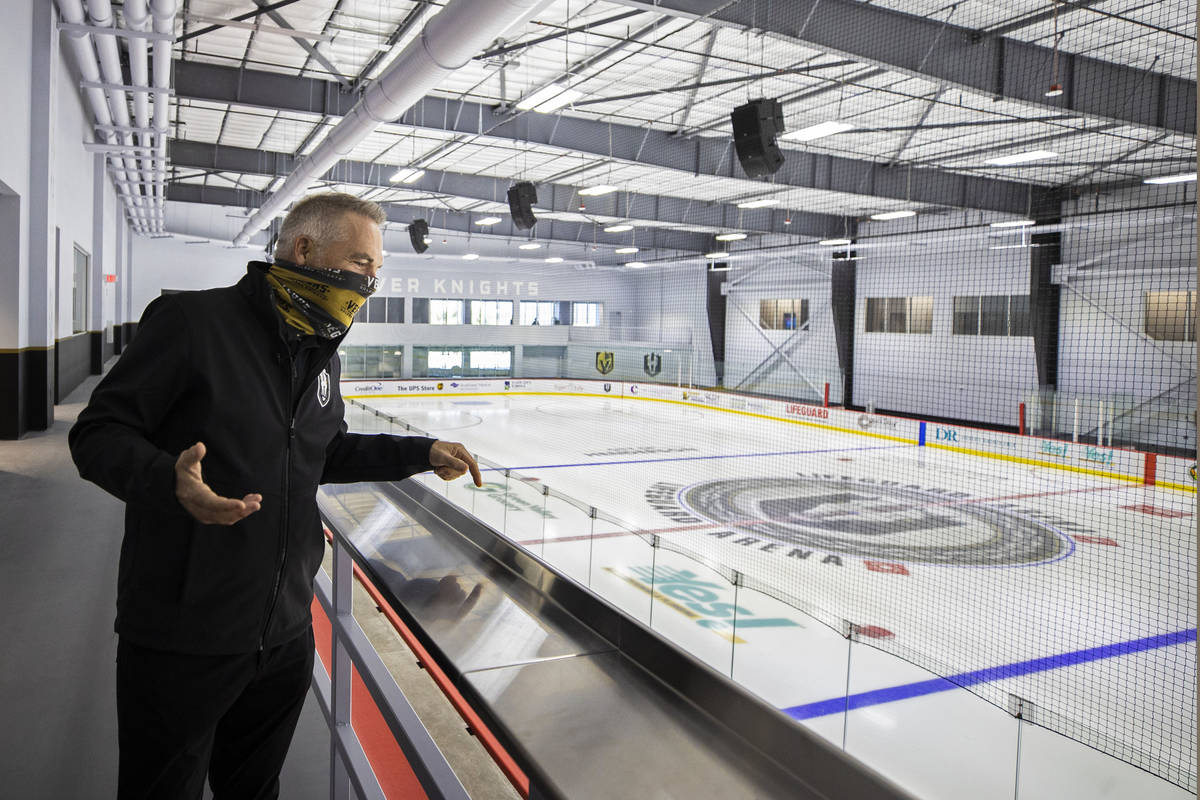 Darren Eliot, vice president of hockey programming and facility operations, points out features ...