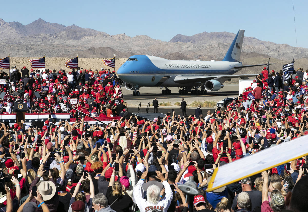 Supporters cheer as Air Force One, carrying President Donald Trump, approaches the stage at Lau ...