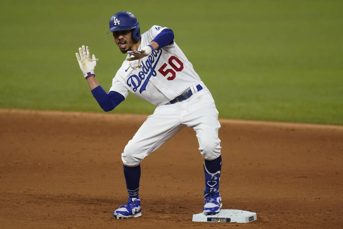Los Angeles Dodgers' Mookie Betts celebrates a double against the Tampa Bay Rays during the six ...