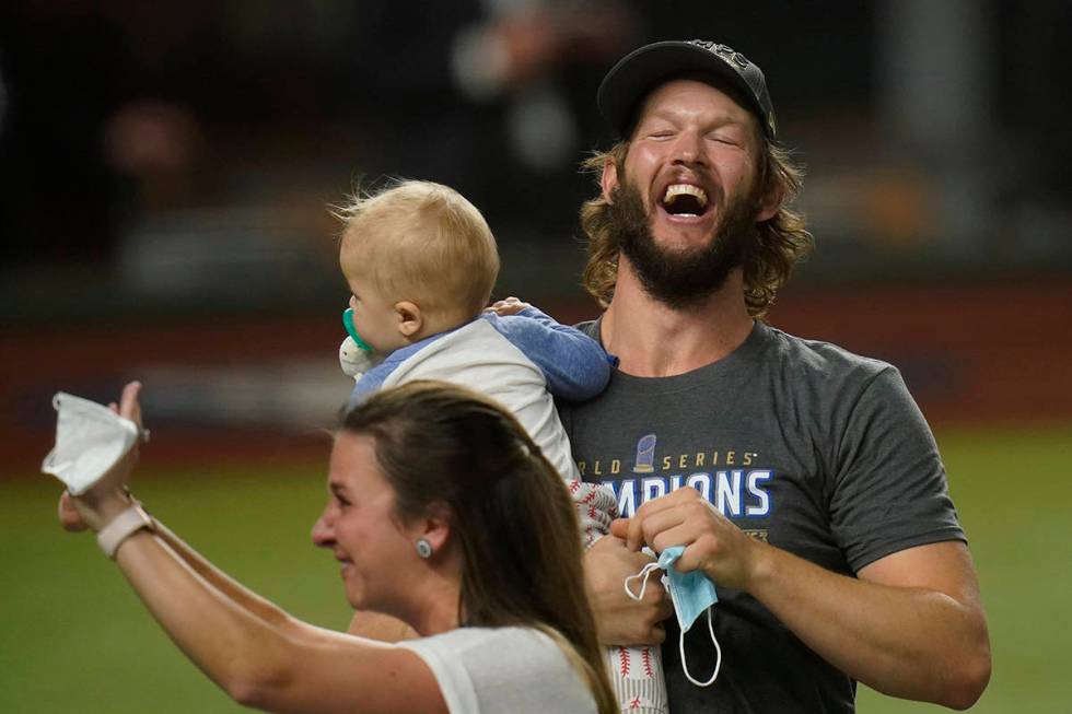 Los Angeles Dodgers pitcher Clayton Kershaw celebrates with family after defeating the Tampa Ba ...