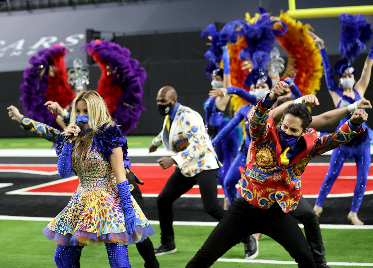 Las Vegas performers, including Lily Arce, left, put on a show at Allegiant Stadium as part of ...