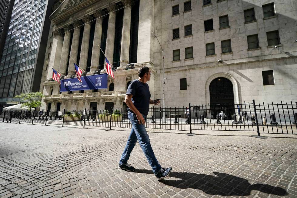 A pedestrian pass the New York Stock Exchange, Friday, Oct. 2, 2020, in New York. Stocks aroun ...