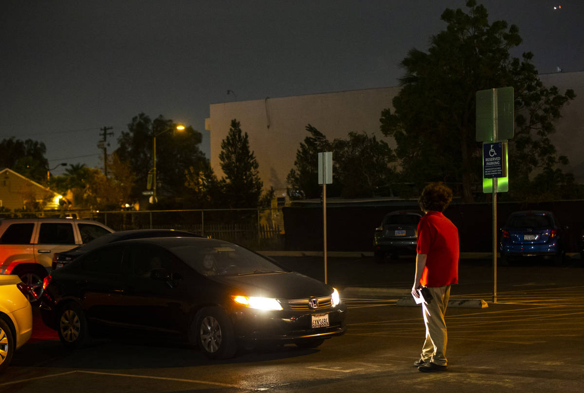 Adam Winteler waits to guide in the next car for the Horrorwood Video drive-in at the Majestic ...