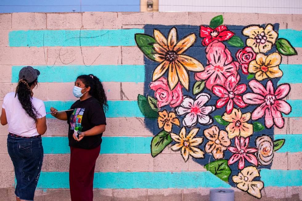 Artists Angie Castillo, left, and Vivian Avila work on a mural at the site of the former Moulin ...
