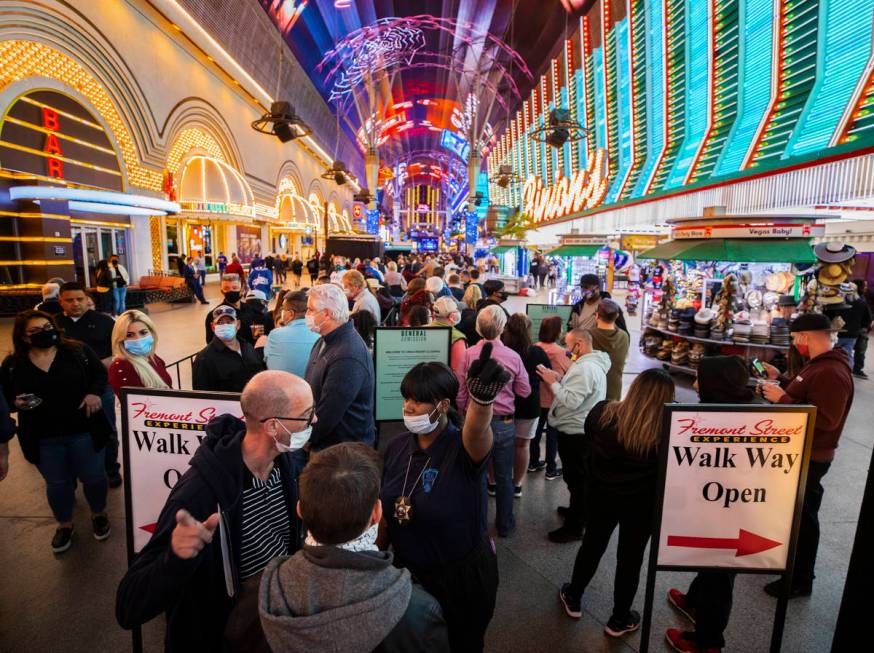 People wait in line for blocks at the Fremont Street Experience to enter Circa during the resor ...