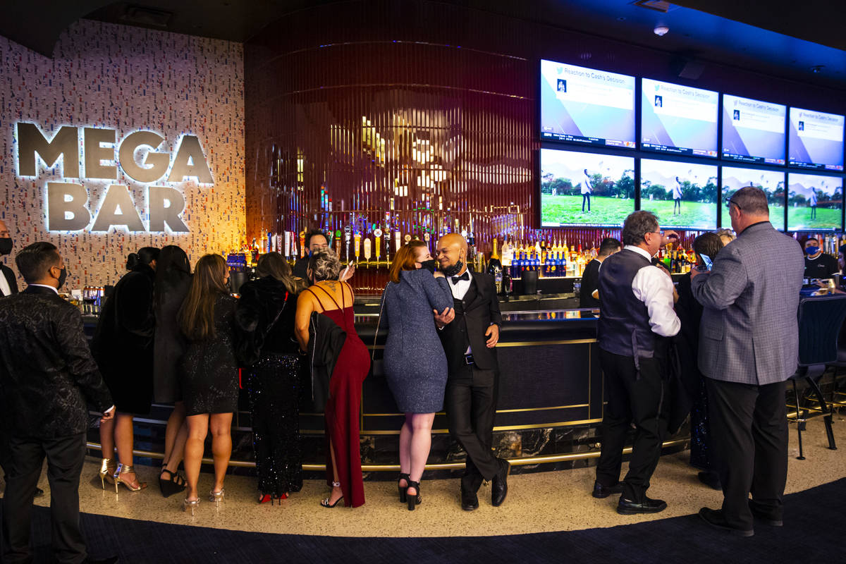 People relax by the Mega Bar at Circa as it opens to the public just after midnight in downtown ...
