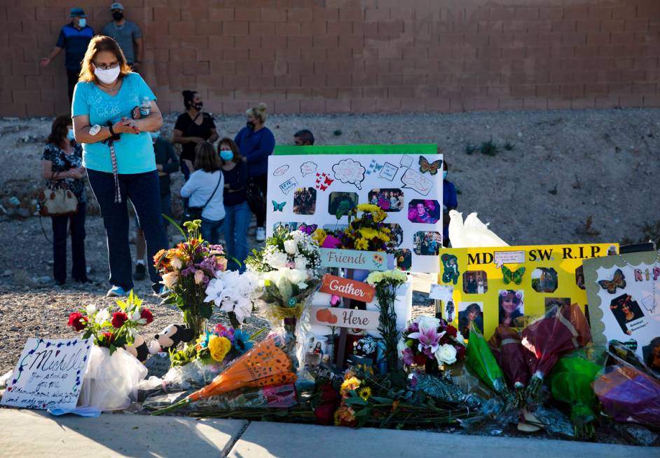 Flowers and photos at a makeshift memorial in honor of Michelle Weissman, a bicyclist killed Su ...