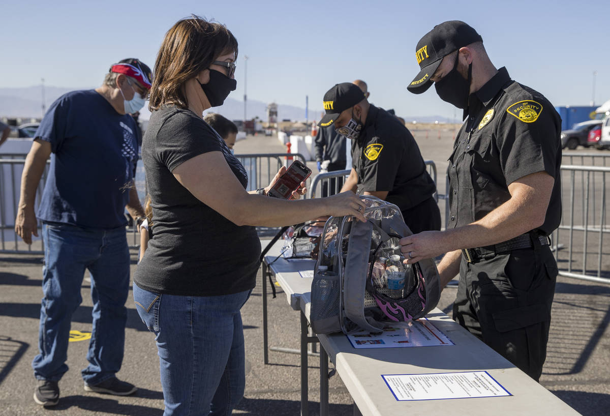 Fan Rose Jaramillo, center, has he bag checked by security as the Las Vegas Motor Speedway host ...