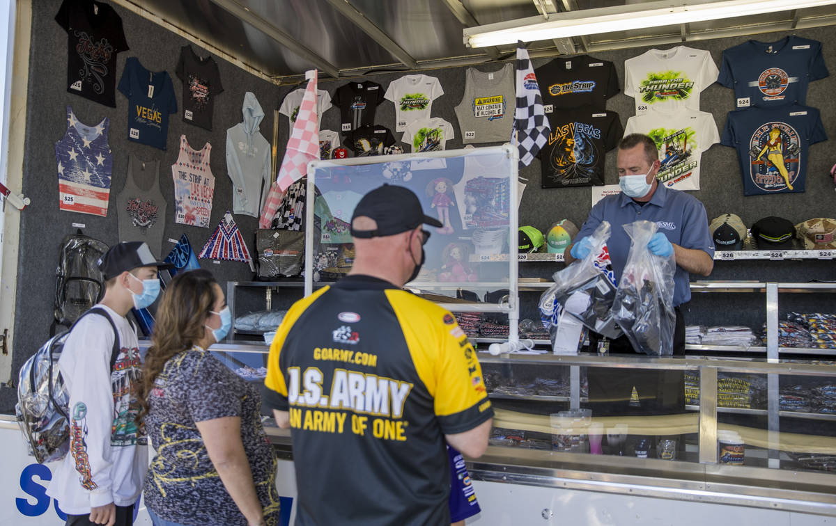 The Roberts family receive some souvenirs near the track as the Las Vegas Motor Speedway hosts ...