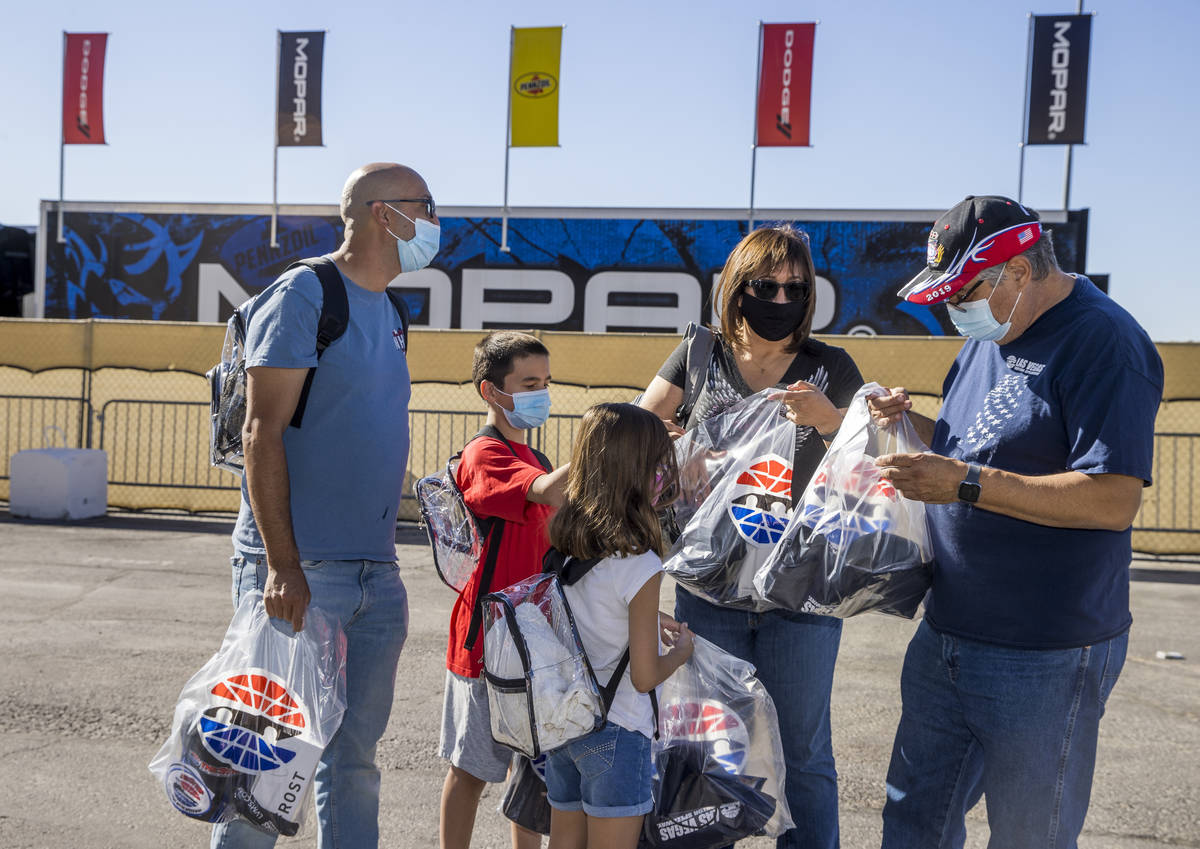 (From right) Race fans Santiago, Rose, Quinn, 8, Aiden, 11, and Matthew Jaramillo check out the ...