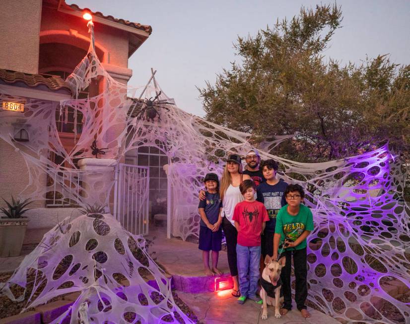 Tiffany and Leroy Garcia are photographed with their four sons in front of their Disney inspire ...