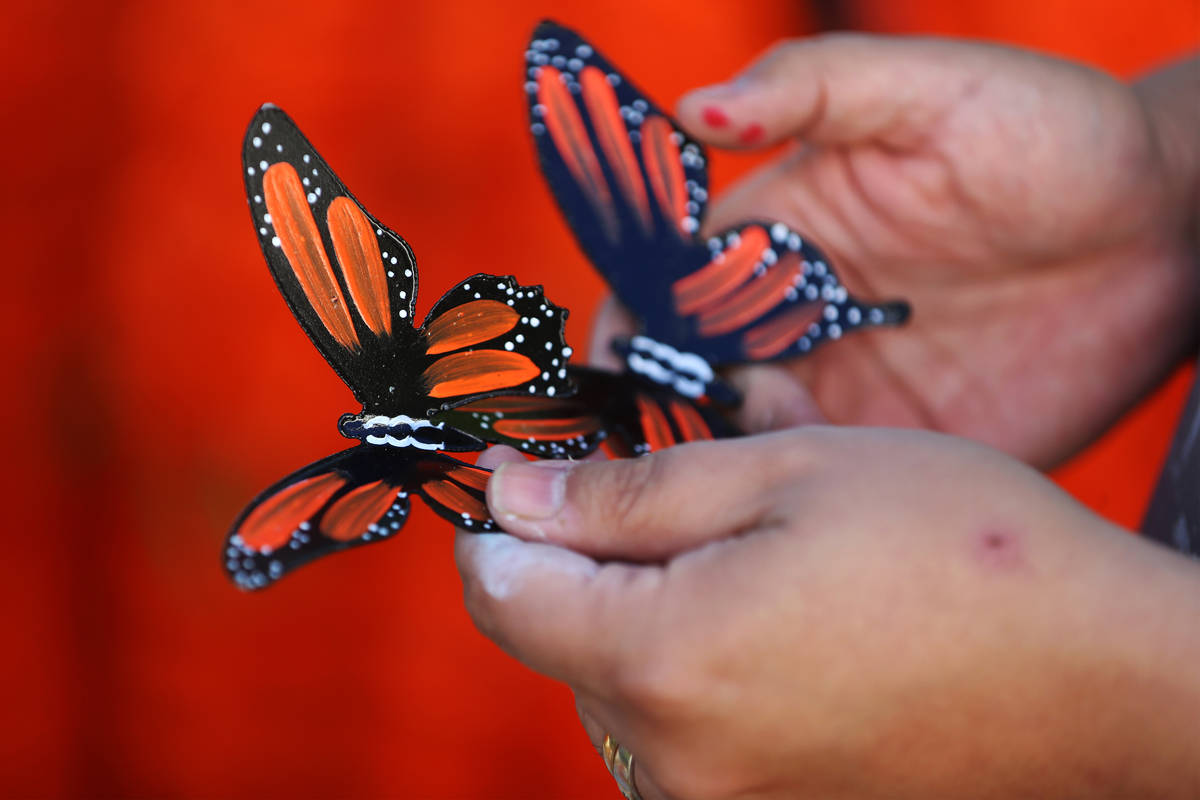 Isaias Urrabazo holds butterflies he created that will be part of his Dia de los Muertos altar, ...