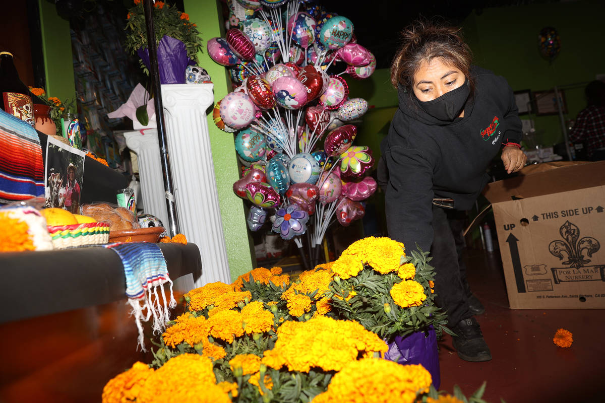 Flor Santos organizes Mexican marigold bouquets, also know as Cempasuchil, at Santos Flowers sh ...