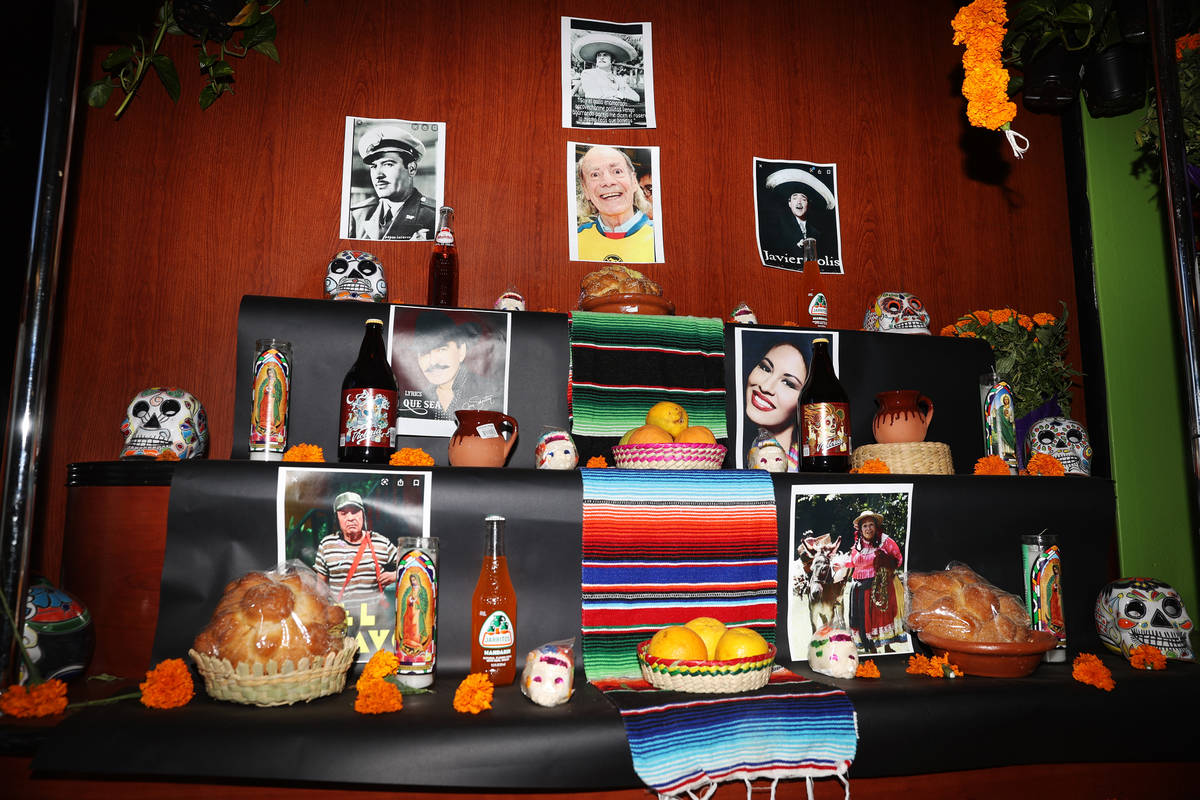 An altar with pictures of Mexican entertainers and musicians and decorated with sugar skulls, c ...