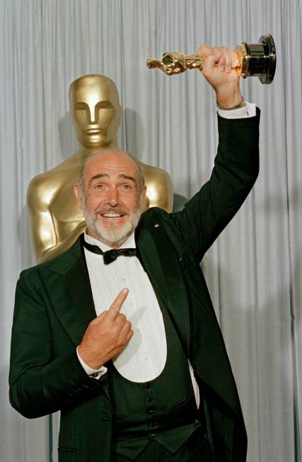 FILE - In this file photo dated April 11, 1988, Sean Connery holds up his best supporting actor ...