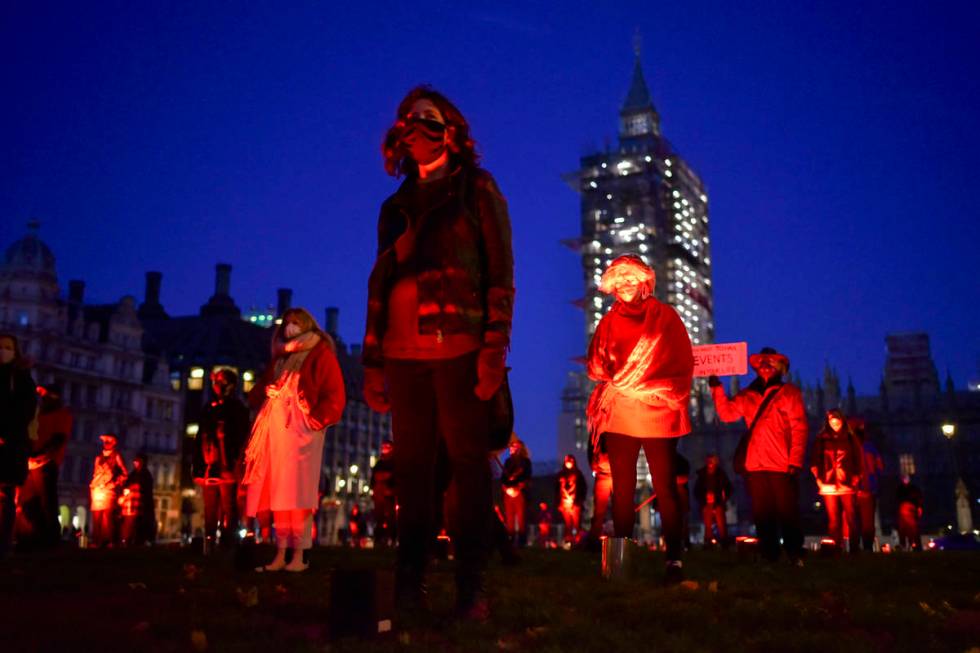 Demonstrators hold a silent vigil in Parliament Square to rise awareness on entertainment and a ...