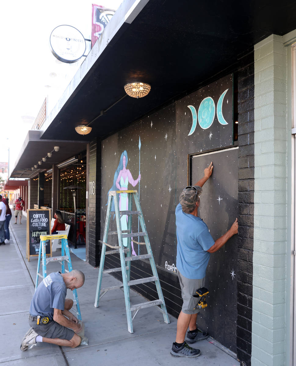 John Coker, right, and Daniel Haner board up windows in preparation for Election Day at Grrrl a ...
