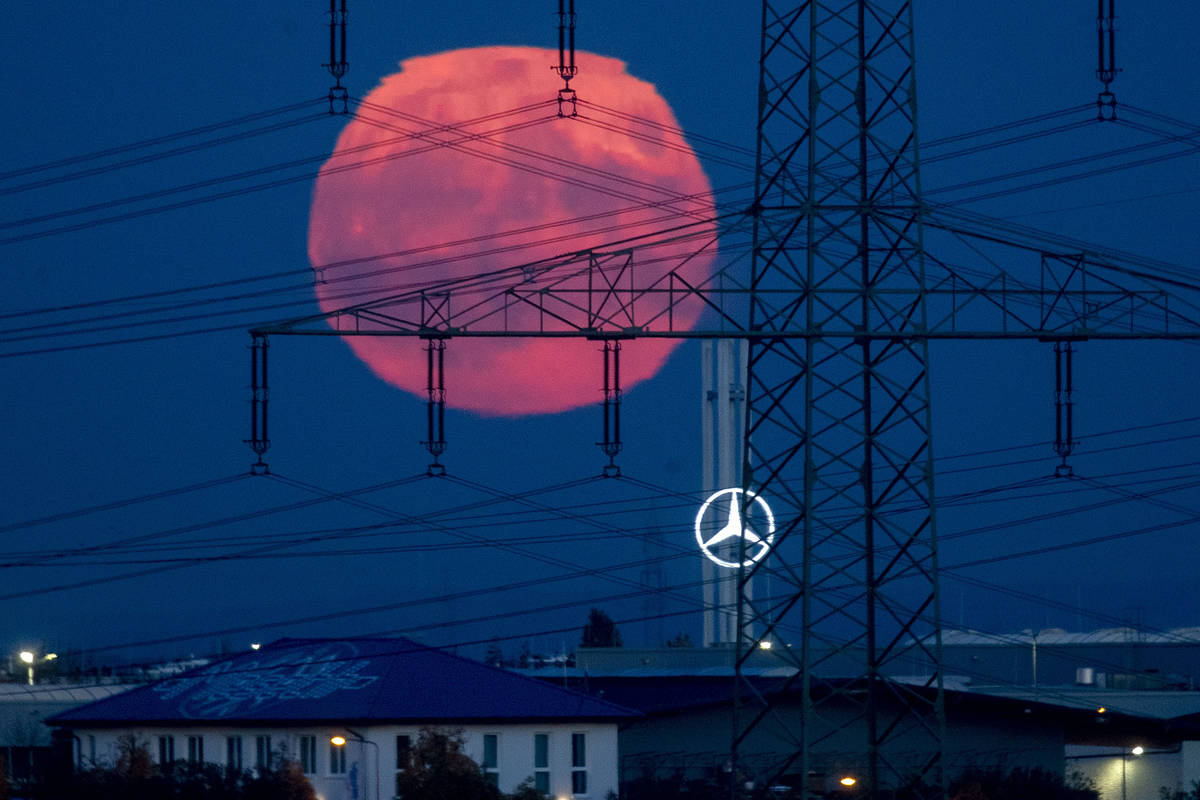 The full moon rises over the outskirts of Frankfurt, Germany, Saturday, Oct. 31, 2020. The ful ...
