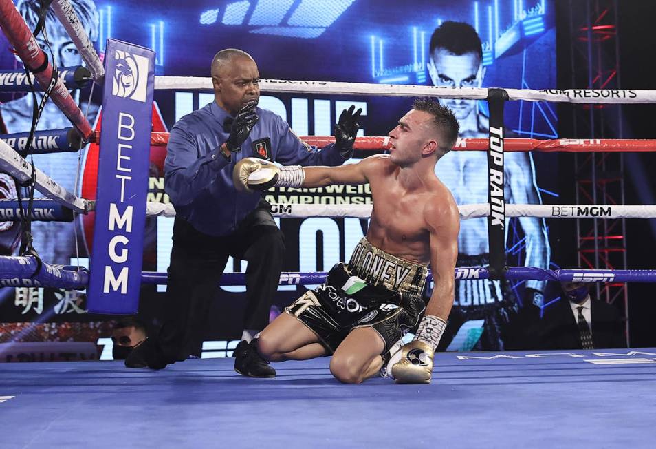 Jason Moloney is knocked down by Naoya Inoue during their bantamweight title fight Saturday at ...