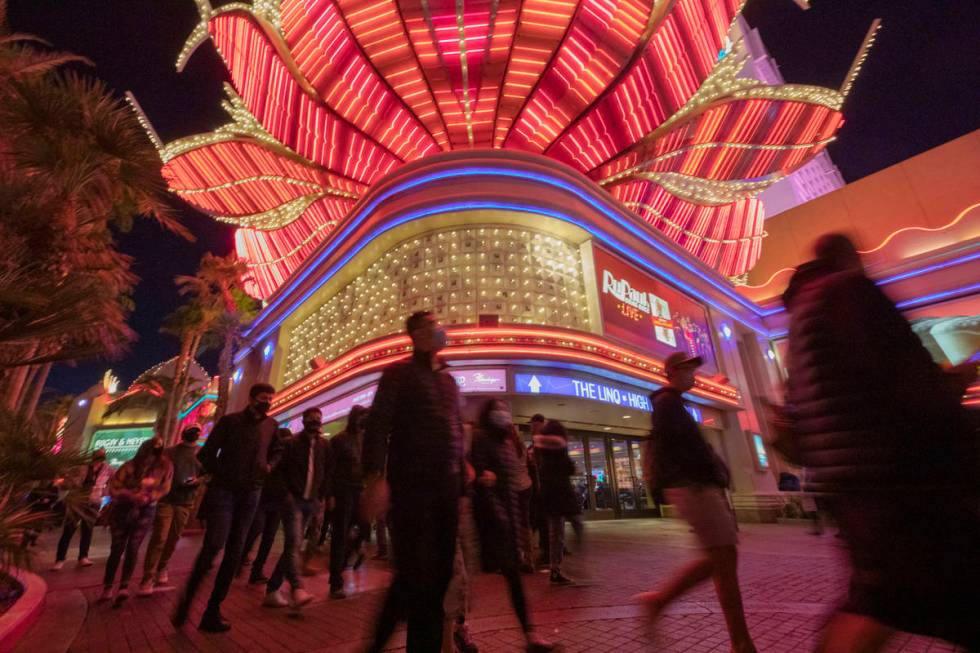 Tourists walk near the Flamingo casino-hotel on the Strip on Friday, Nov. 27, 2020, in Las Vega ...