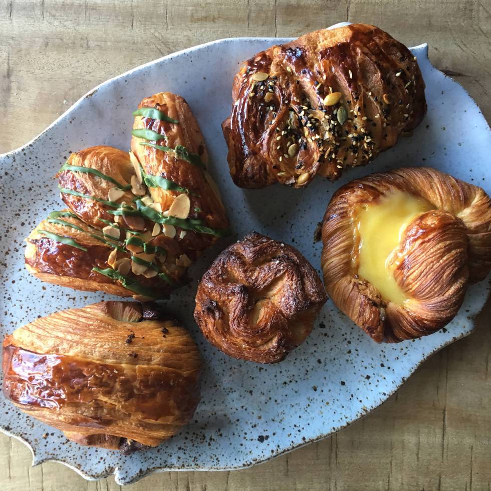 Clockwise from top left: matcha bearclaw croissant filled with almond and finished with green t ...