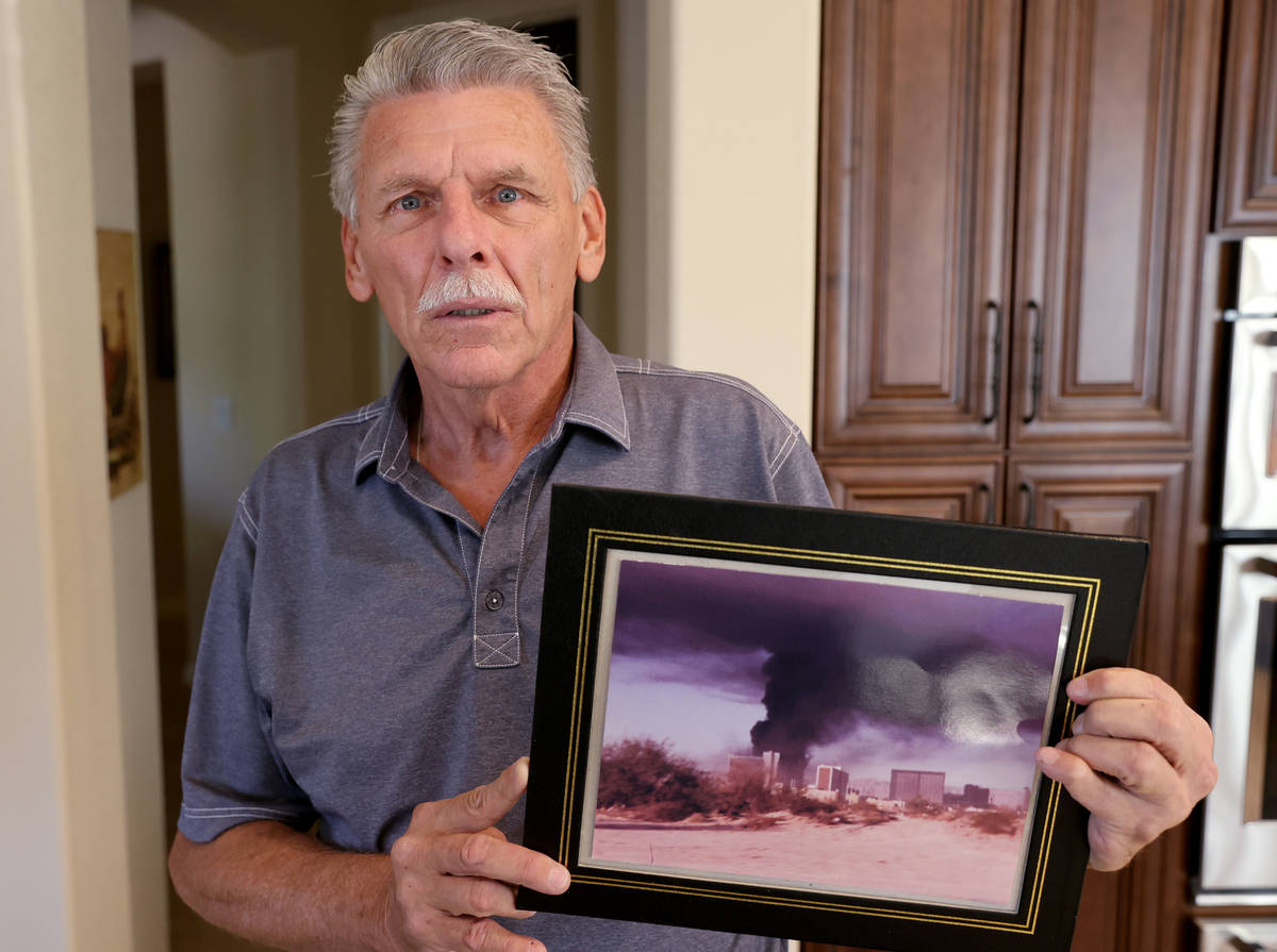 Retired Clark County Fire Department Capt. Jerry Bendorf shows a photo of the MGM Grand fire at ...