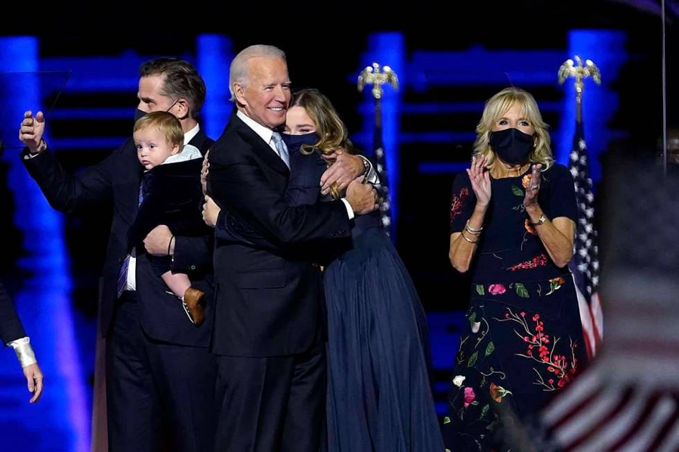 President-elect Joe Biden, with his Jill Biden, right, and members of this family on stage, Sat ...
