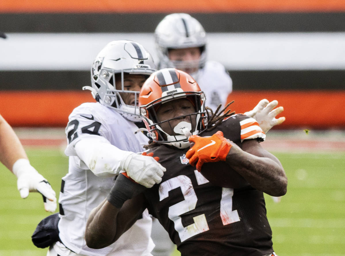 Las Vegas Raiders strong safety Johnathan Abram (24) tackles Cleveland Browns running back Kare ...