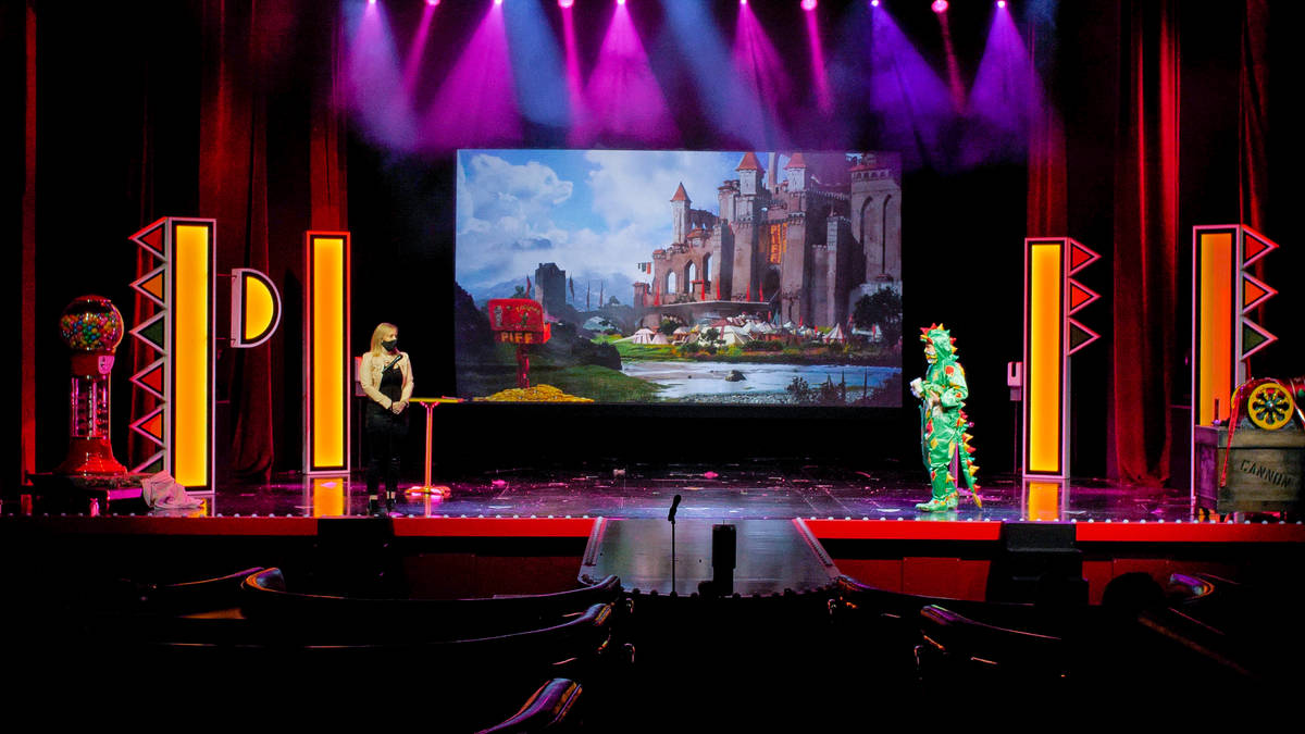 Piff The Magic Dragon (John van der Put) is shown onstage with a socially distant audience memb ...