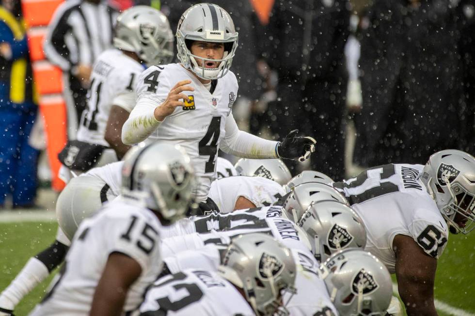 Las Vegas Raiders quarterback Derek Carr (4) calls an audible in the snow in the second quarter ...