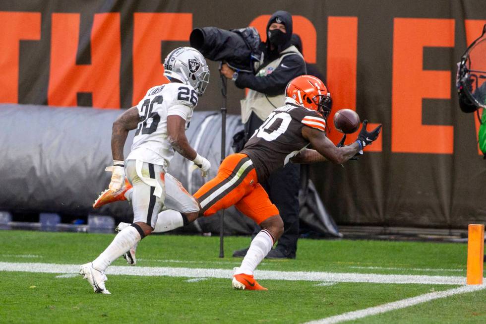 Cleveland Browns wide receiver Jarvis Landry (80) reaches for the football as Las Vegas Raiders ...