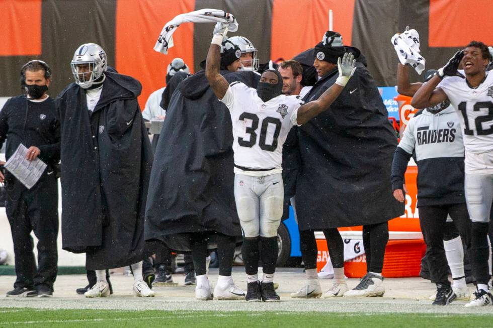 Las Vegas Raiders running back Jalen Richard (30) waves a towel in the air to celebrate a defen ...