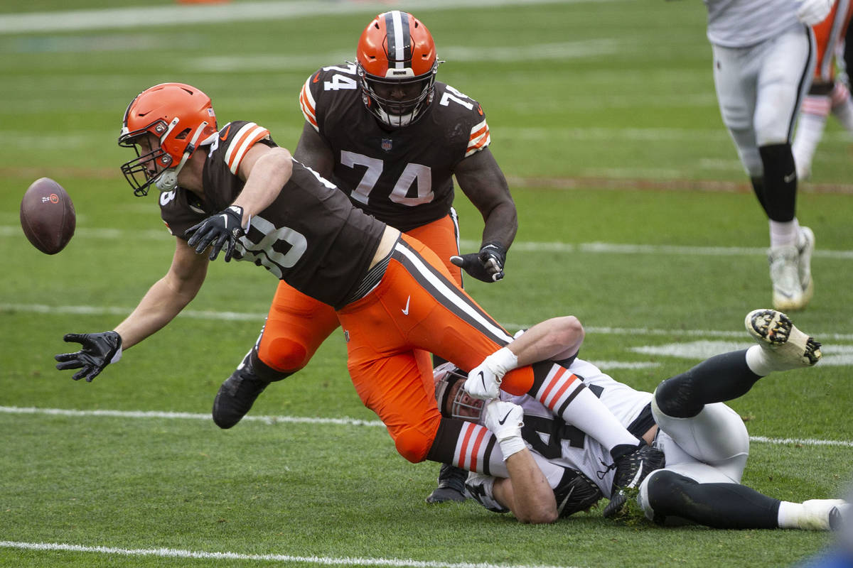Cleveland Browns tight end Harrison Bryant (88) fumbles the football while being tackled by Las ...