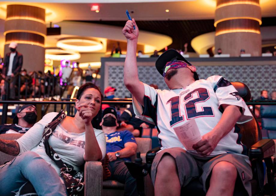 Rachel Randall, left, and her friend Jesus “Chuy” Baca, right, watch NFL Sunday at the new ...