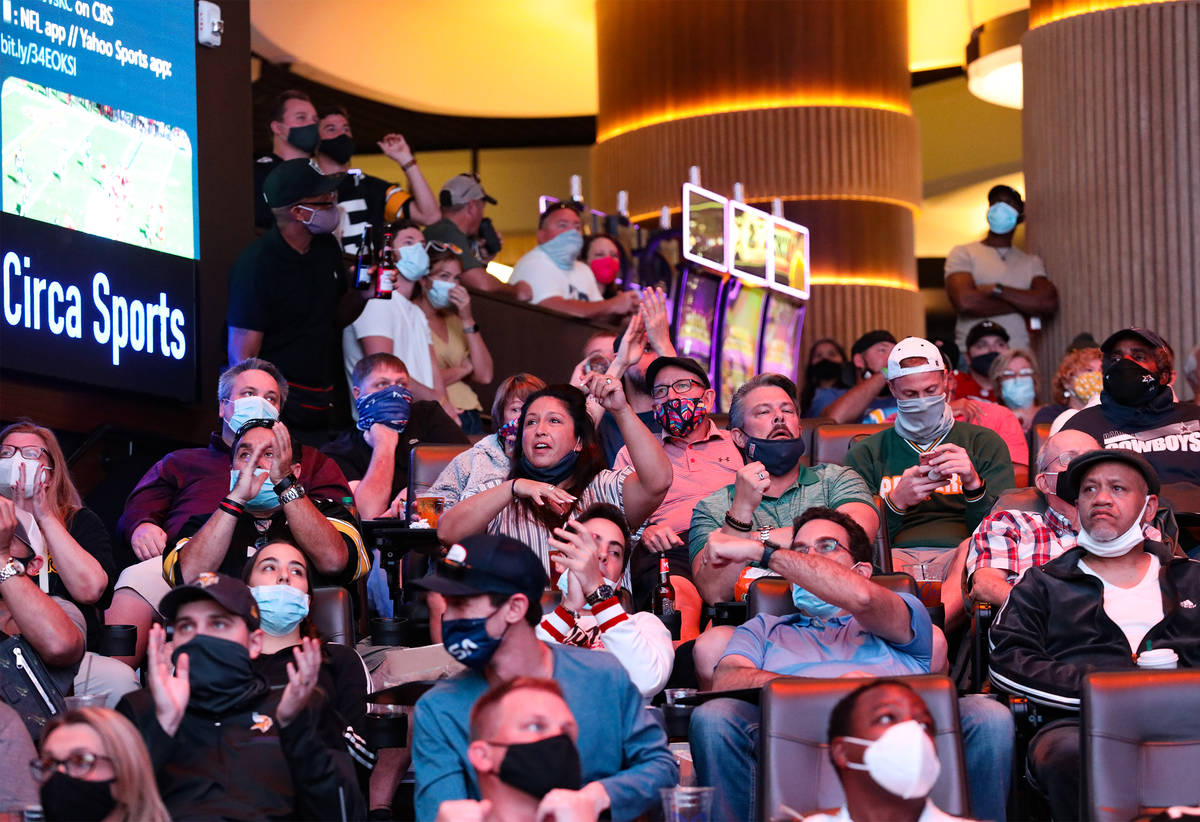 Spectators react to a play while watching NFL Sunday at the new sportsbook at Circa in Las Vega ...