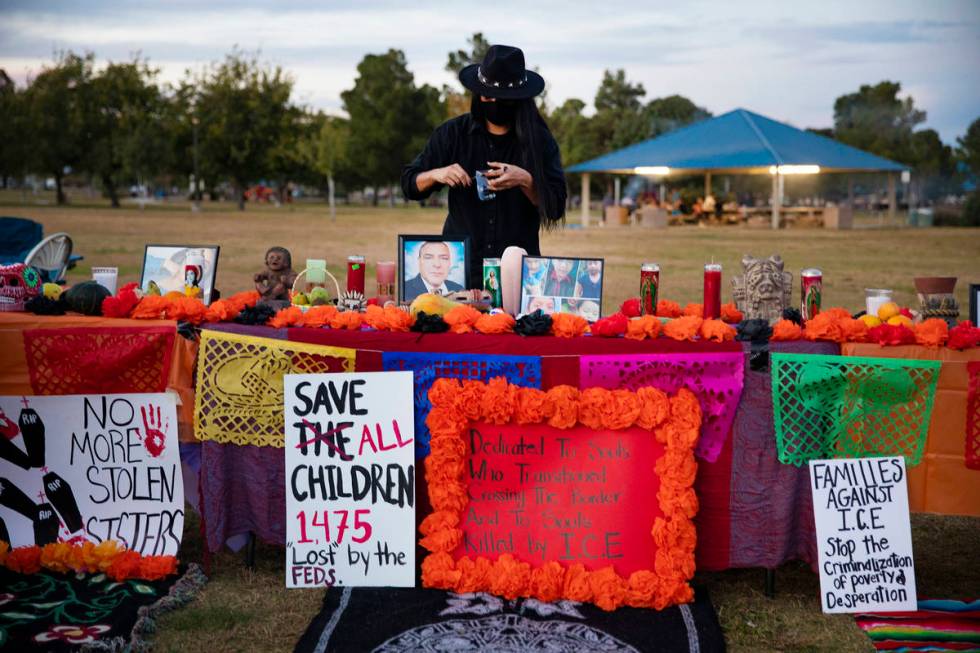 Davis Huskon sets up an ofrenda at a Día de los Muertos event to honor people killed by po ...